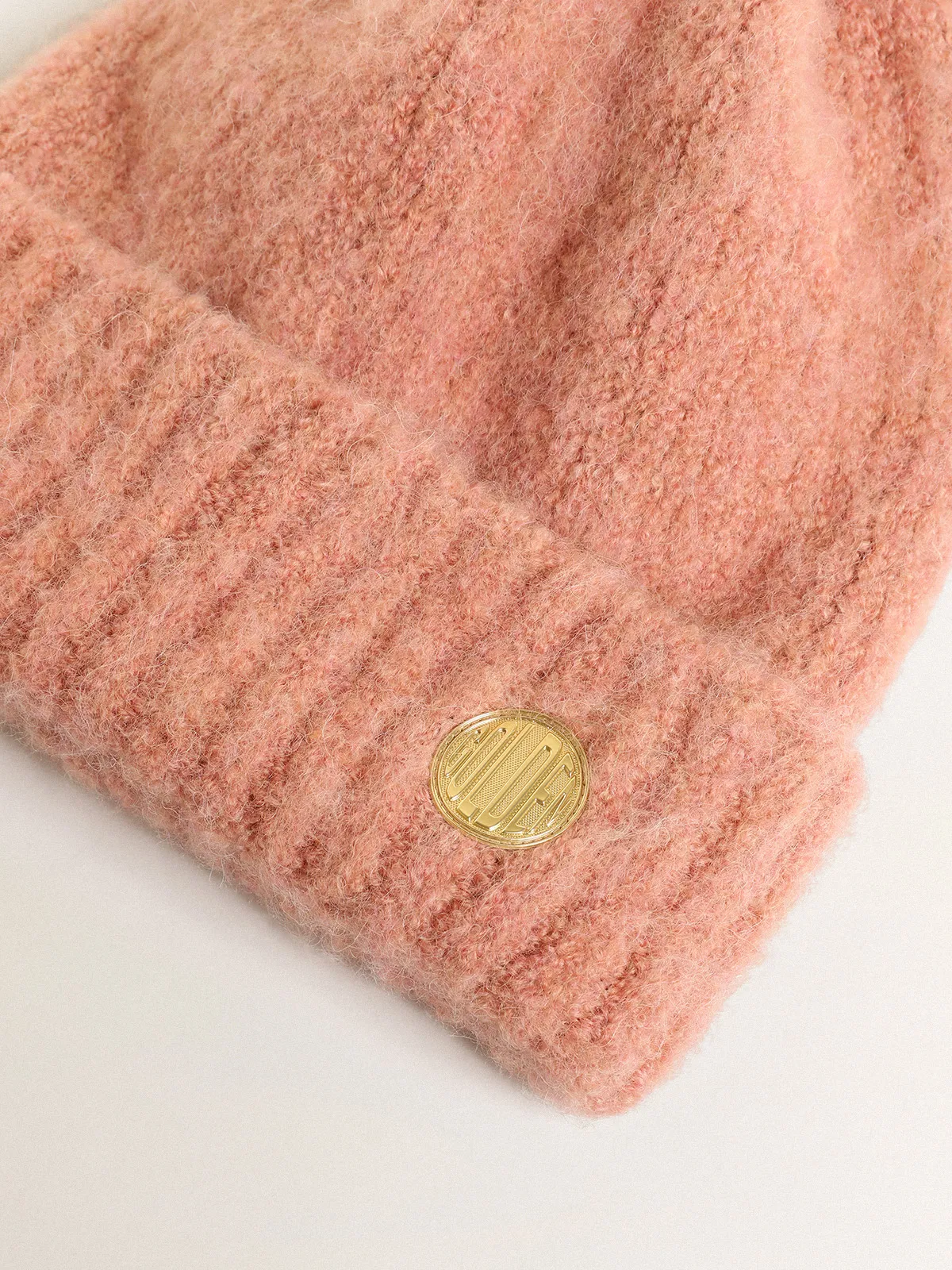 Pale pink wool beanie with pompom