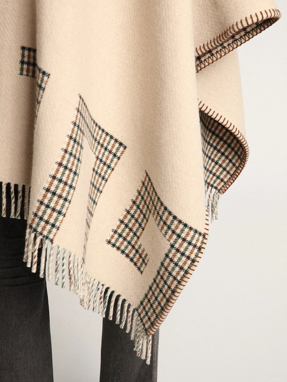 Poncho in double face cream-colored wool with check pattern and lettering