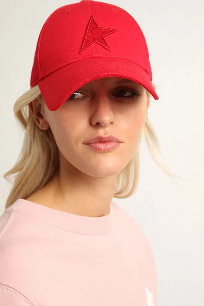 Red cotton baseball cap with tone-on-tone star-shaped patch on the front